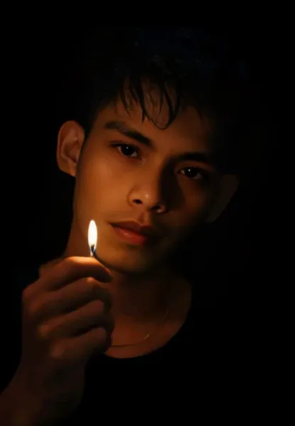 Cinematic Dark Match-Lit Portrait of Young Man Chatgpt Prompt