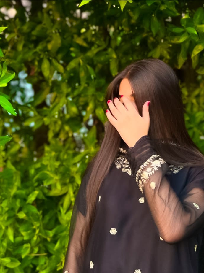 A wonderful photo has been taken of a very pretty girl looking very sweet in a black dress and a dress