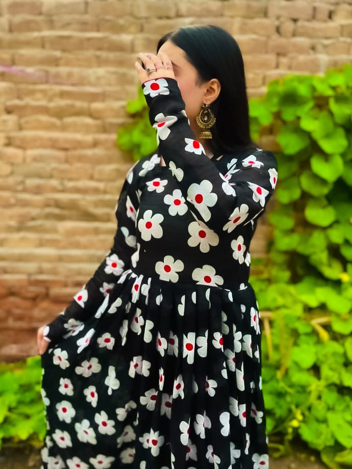 A girl in black wearing clothes looking beautiful against a background of orange and green A cute photo of a girl hiding her face